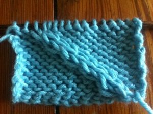 Example of the Twist 4 Front Cable Stitch on a Reverse Stockinette panel